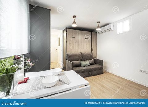 Studio Apartment With A White Folding Dining Table With A Fake Vase, A ... in How to Choose the Perfect Foldable Dining Table That Fits Your Studio Lifestyle